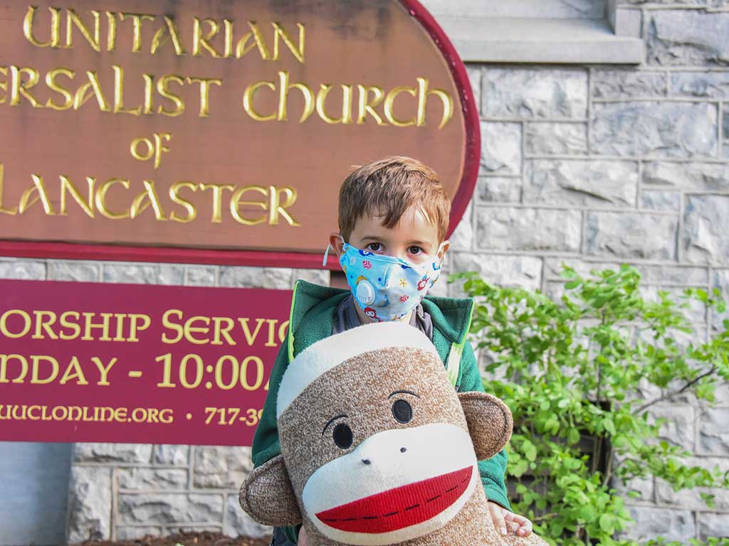 Child with toy at Unitarian Universalist Church Sign